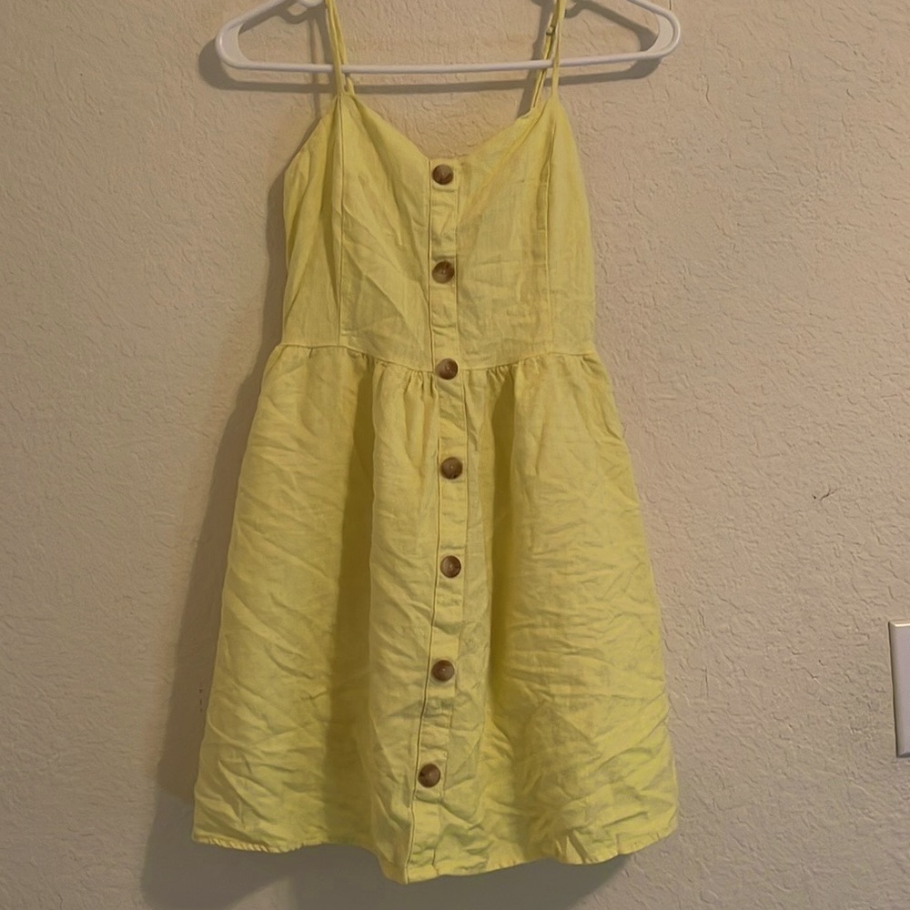 This is a beautiful yellow summer dress with buttons coming form the middle.
